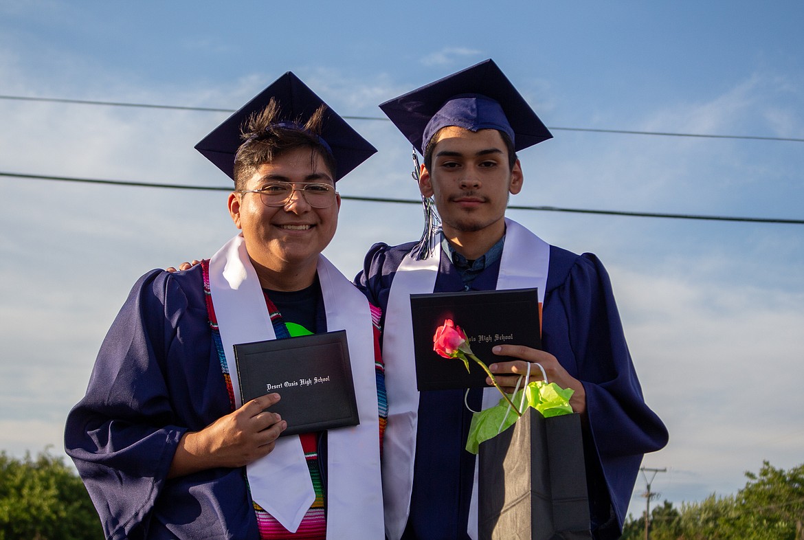 Casey McCarthy/The Sun Tribune 
 Julian Flores and fellow Desert Oasis graduate Pedro Villanueva pose for a photo together after celebrating their 2020 graduation last Thursday evening in Othello.