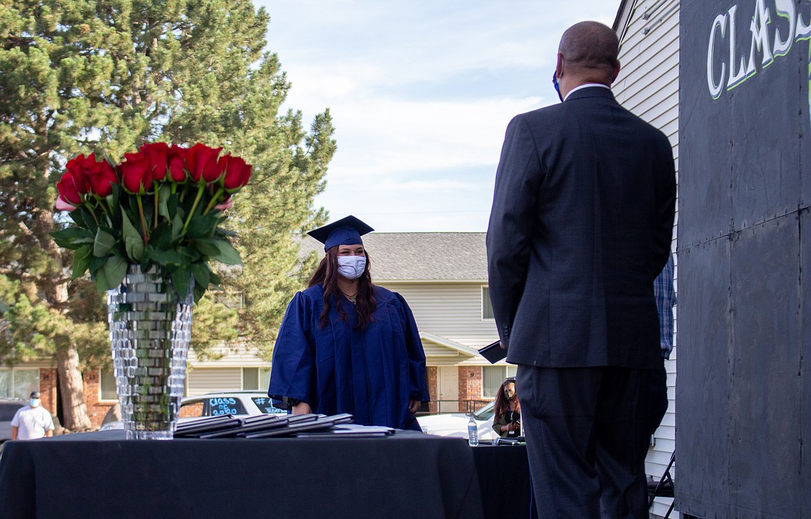 Casey/The Sun Tribune 
 Desert Oasis High School graduate Kenisha Bailey makes her way towards the stage last Thursday as Othello School District Superintendent Dr. Kenneth Hurst waits to greet her with Othello School Board member Ken Johnson.