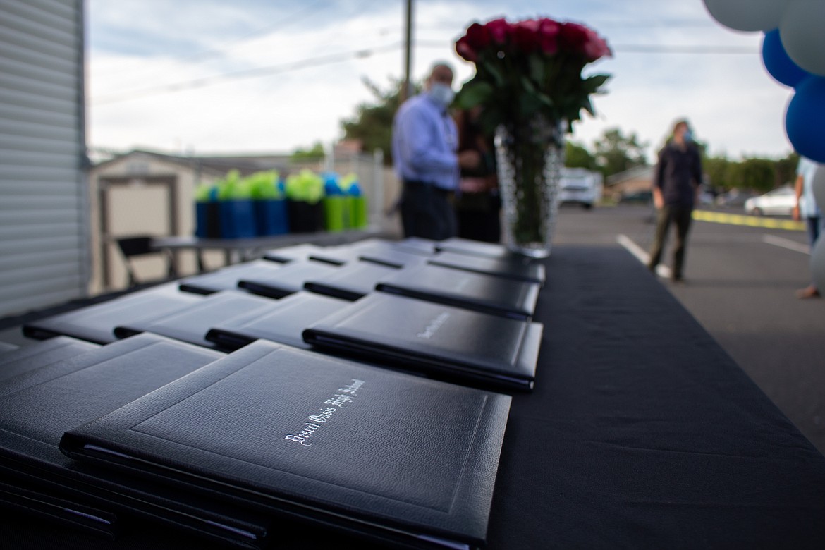 Casey McCarthy/The Sun Tribune
Diploma covers fill the table on stage at Desert Oasis High School’s 2020 graduation ceremony last Thursday evening in Othello.