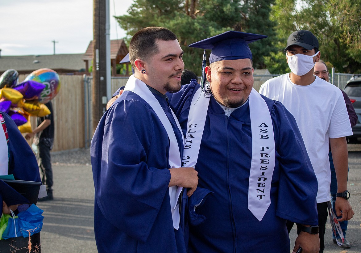 Casey McCarthy/The Sun Tribune 
 2020 Desert Oasis High School graduates Saul Perez and Jesus Garcia celebrate together after making their way across the stage, celebrating with friends and family.