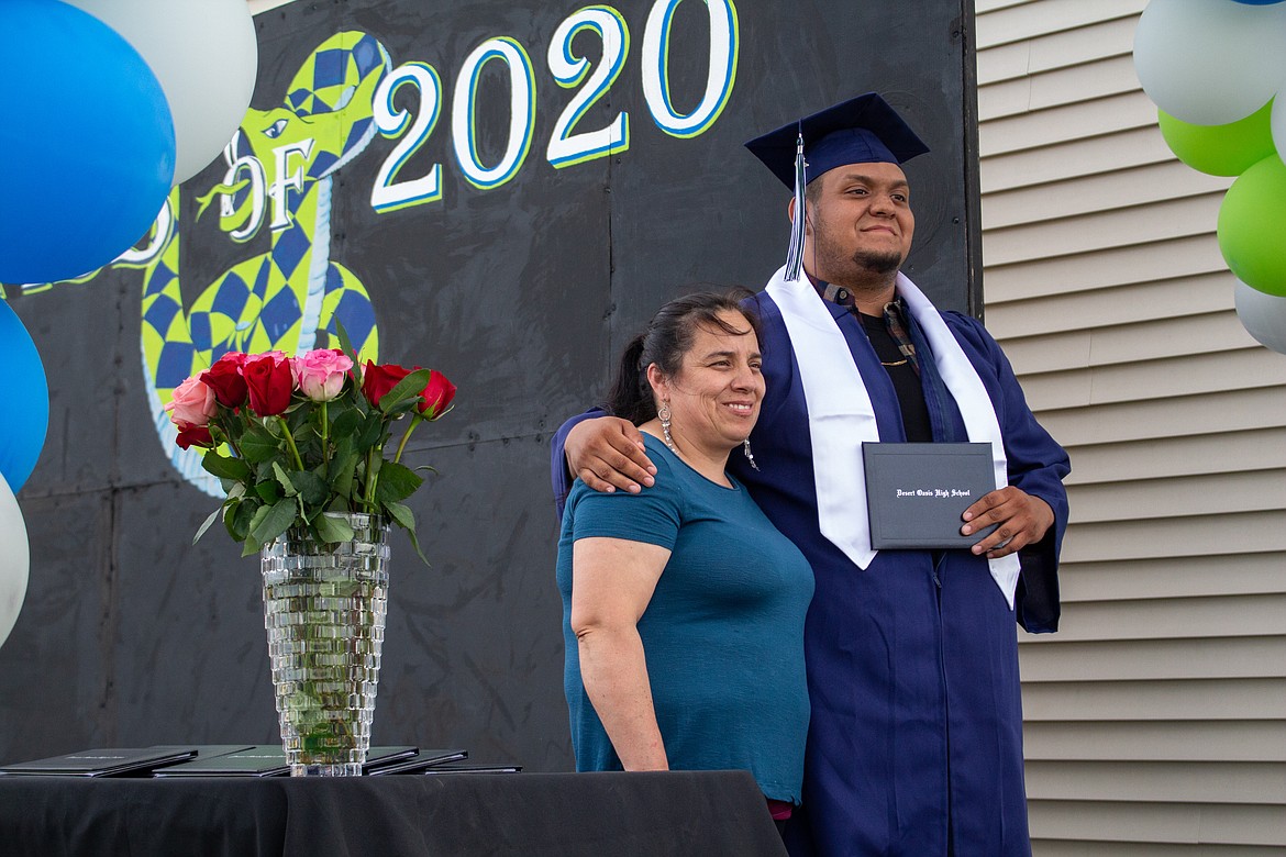 Casey McCarthy/Columbia Basin Herald
Joses Montes smiles with his mother beside him for a photo on stage as he celebrates graduating as a member of Desert Oasis High School’s 2020 class.