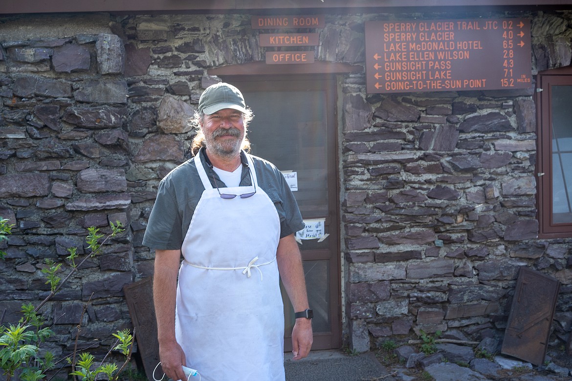 Standing outside the dining hall, Michael Warrington takes a short break from kitchen duties on the opening day of Sperry Chalet.