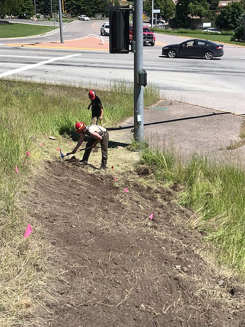 Flathead National Forest employees work on completing a loop trail at the intersection of Holt Drive and Montana 35 on Wednesday, July 15.