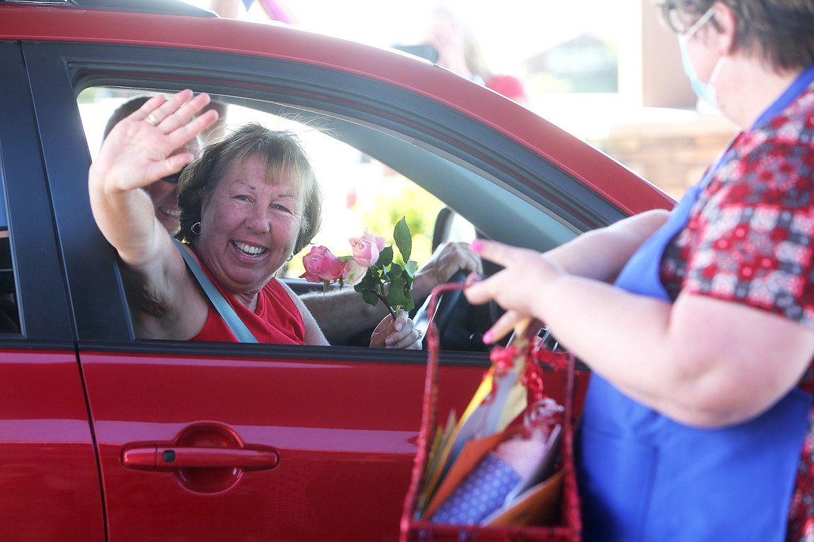 $ID/NormalParagraphStyle:Drivers and passengers wave and wish Harriet Dent a happy birthday as they drive by.