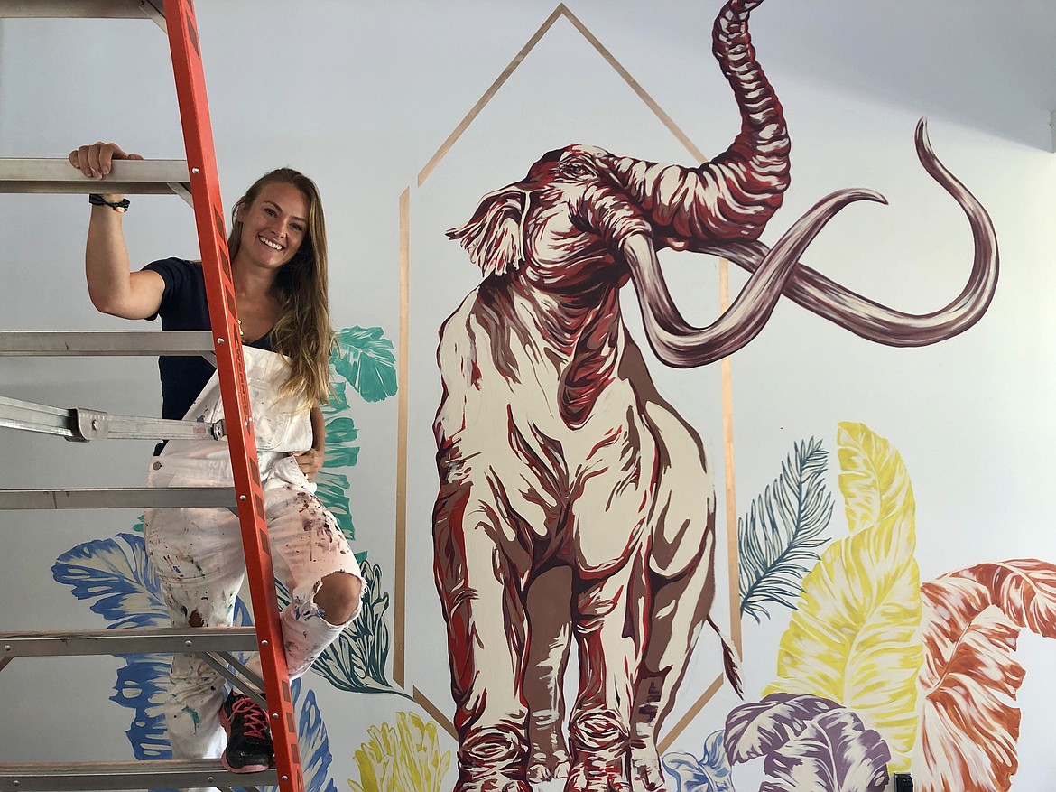 Erika Kovalenko, artistic director of the Moses Lake Museum & Art Center, in front of the mural of a Columbian Mammoth she is painting inside the center’s classroom.