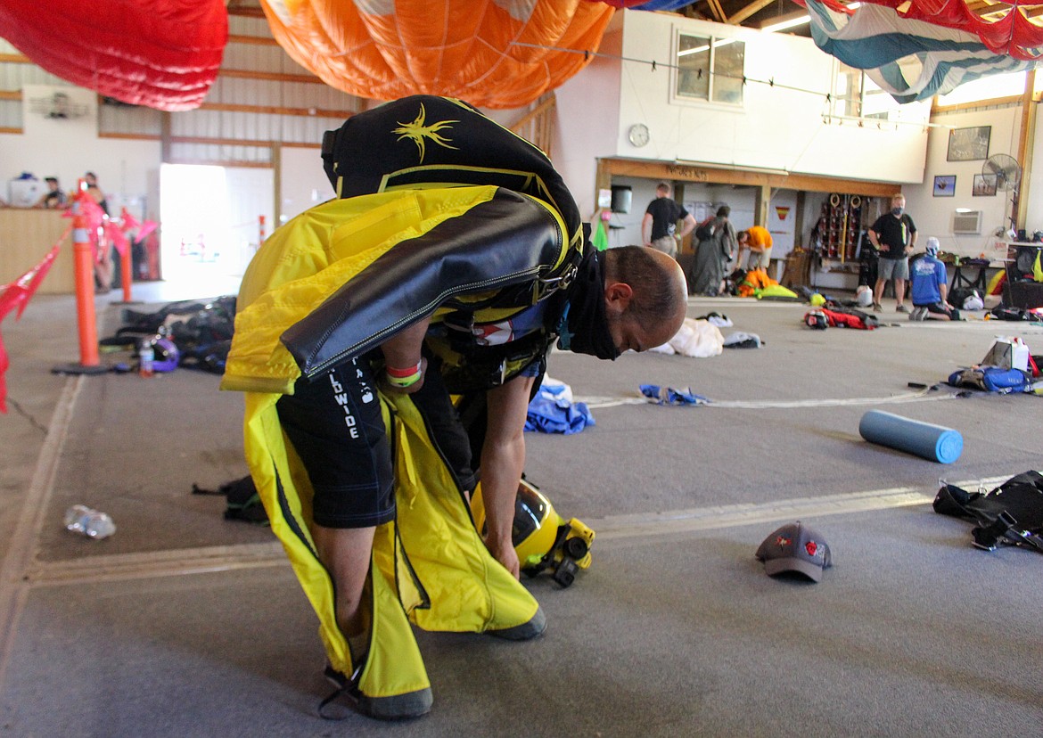 Nikko Mamallo gets suited up inside the hangar at Skydive West Plains before his jump on Sunday afternoon.