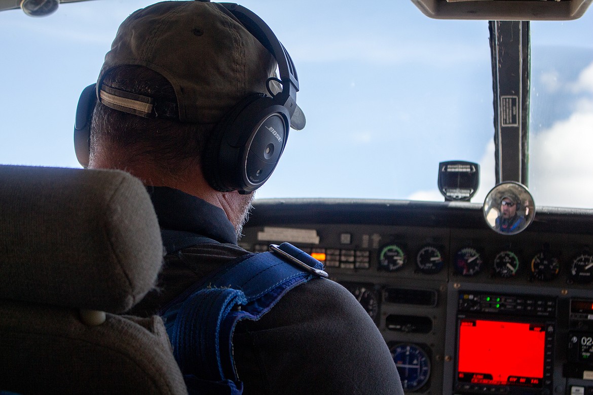 Pilot Dan Jones checks the instruments in his plane as he ascends to drop a load of wingsuiters over Ritzville on Sunday afternoon.