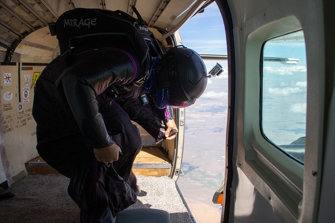 The last wingsuiter left in the plane lowers his head as he leaps out behind his six fellow skydivers on Sunday afternoon over Ritzville.