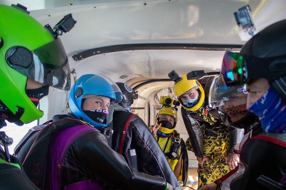 Moments before their jump, wingsuiters enjoy a lighthearted moment before descending back down to Earth from 18,000 feet.