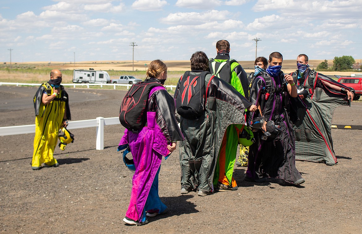 Wingsuiters practice some formations on the ground before ascending for their jump on Sunday afternoon at Skydive West Plains in Ritzville.