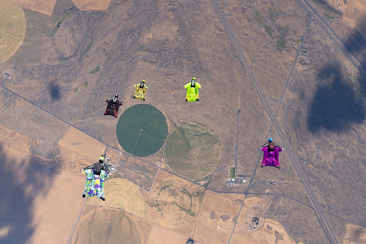 Nikko Mamallo captures a shot of his fellow wingsuiters as they slowly head back toward the earth on Sunday, July 19.