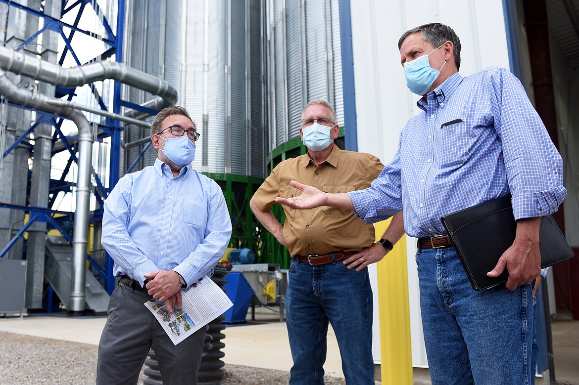 Sen. Steve Daines, right, speaks to a group assembled during a tour with U.S. Environmental Protection Agency Administrator Andrew Wheeler, left, and Montana Attorney General Tim Fox, of Glacier Rail Park on Friday.