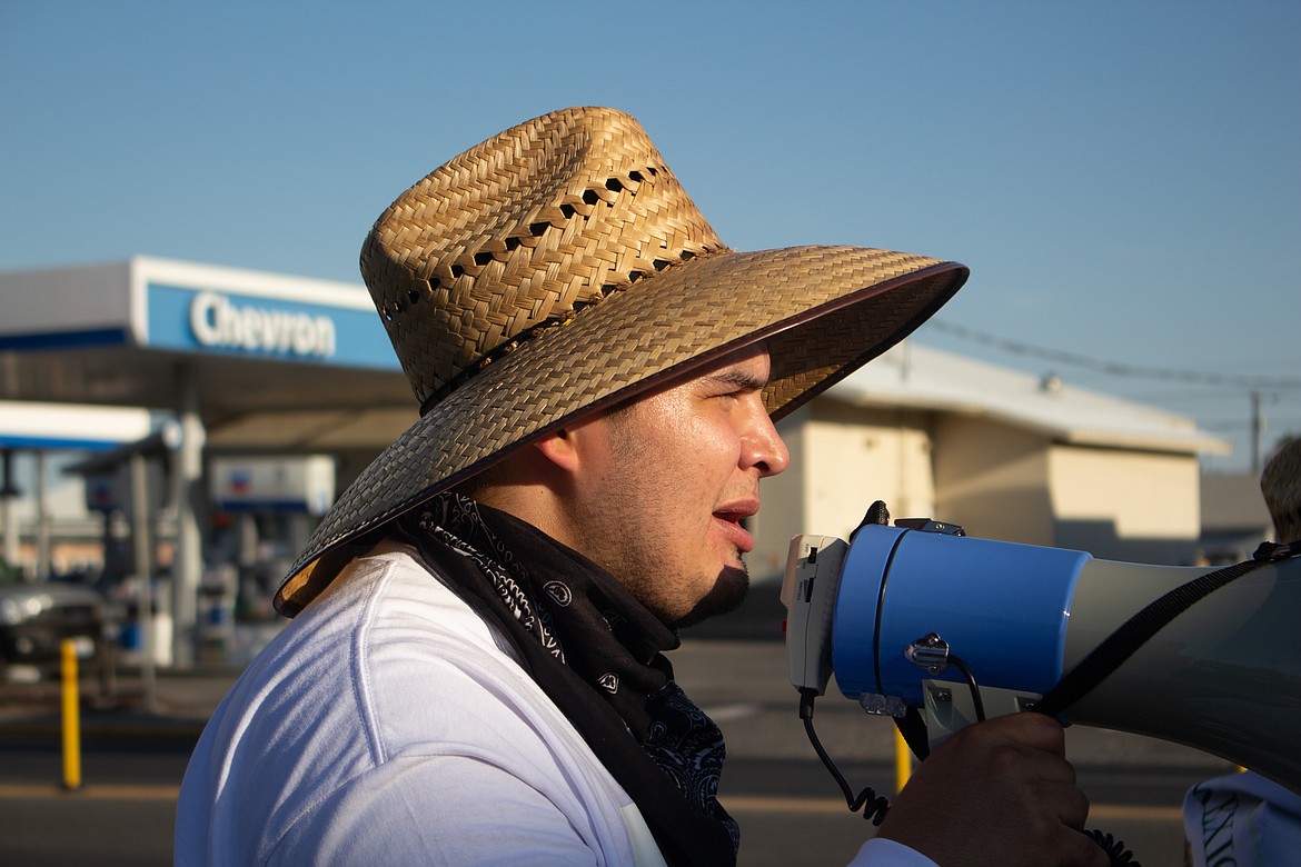 Casey McCarthy/Columbia Basin Herald 
 State representative candidate Eduardo Castañeda-Diaz speaks during a march for farm workers rights in Quincy.