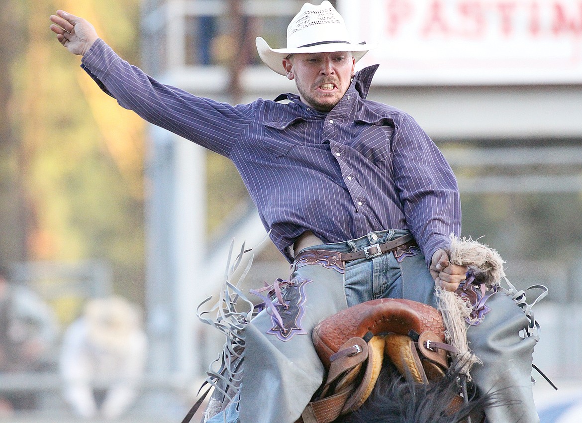 Friday night saddle bronc riding with Kade Bruno from Challis, idaho aboard "Wall Street Jr. (Paul Sievers/The Western News)