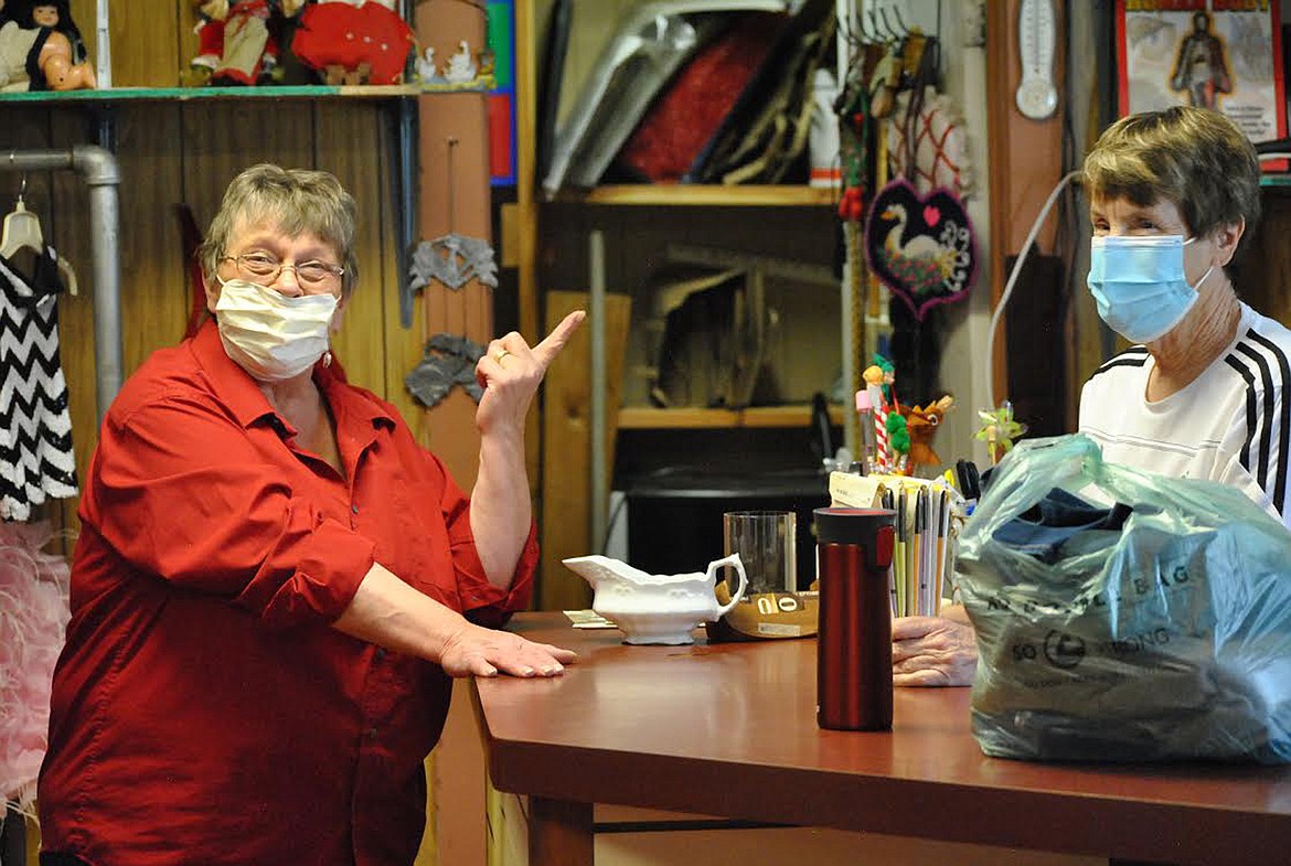 Norma Stepan and Linda Christofferson take a break between customers last Tuesday. They both laughed that it’s harder to recognize people with their masks on. Women in Timber is asking that customers wear masks while shopping during store hours on Tuesdays and Fridays from 10 a.m. to 2 p.m. (Amy Quinlivan/Mineral Independent)