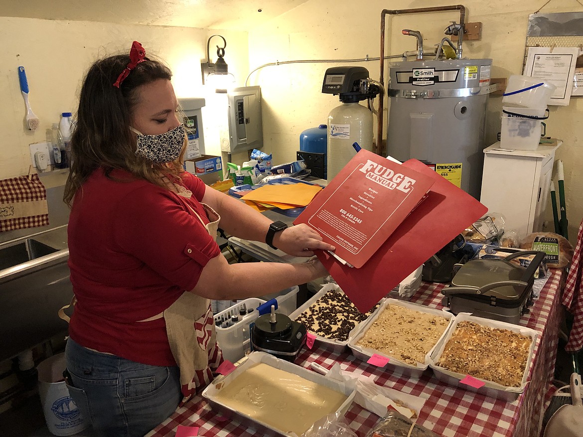 Amy Phillips holds up the Calico Cottage “Fudge Manual,” the guide to fudge making used by Country Cousins.