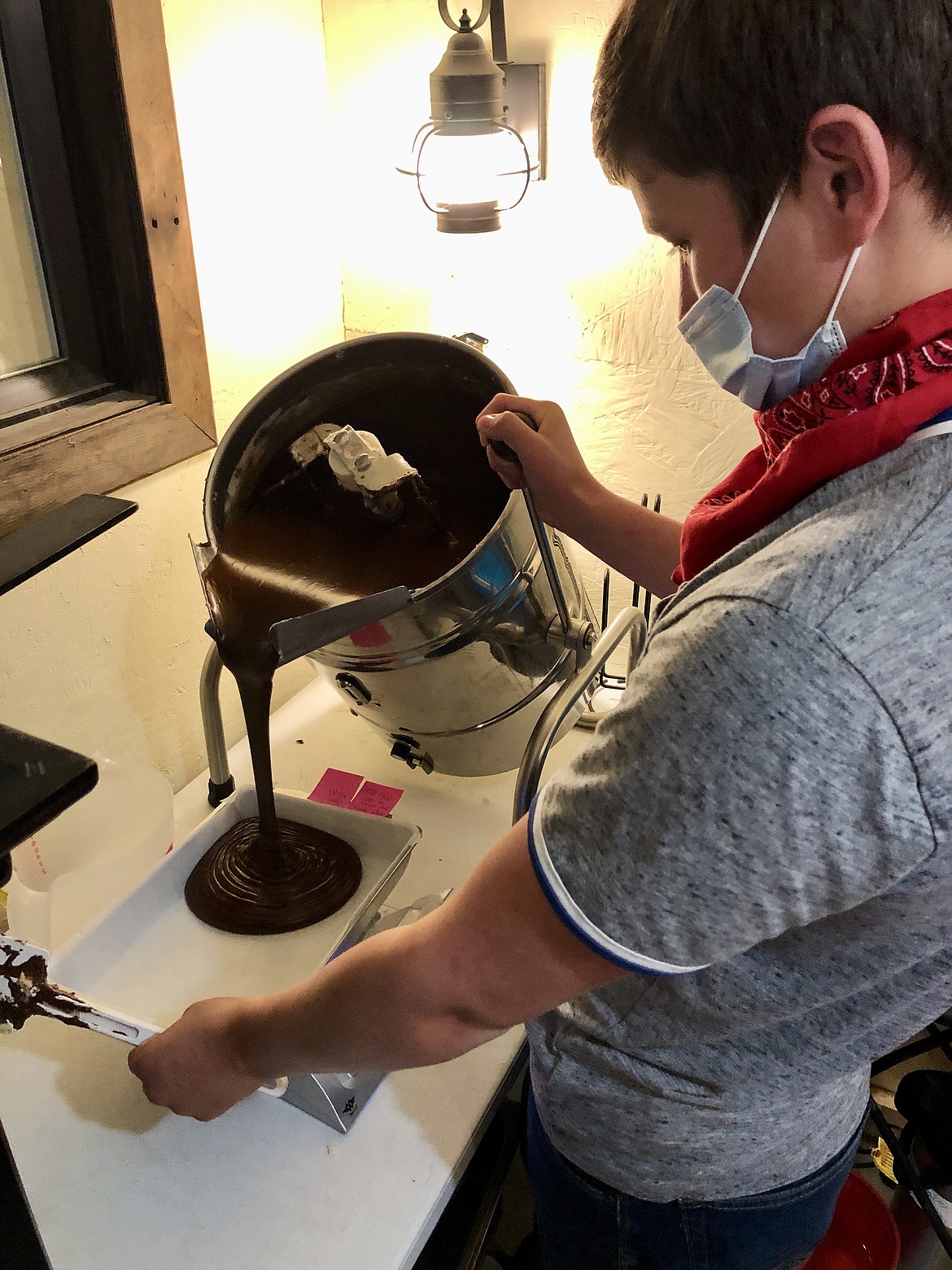 Dallin Freeman, 17, pours out chocolate fudge.