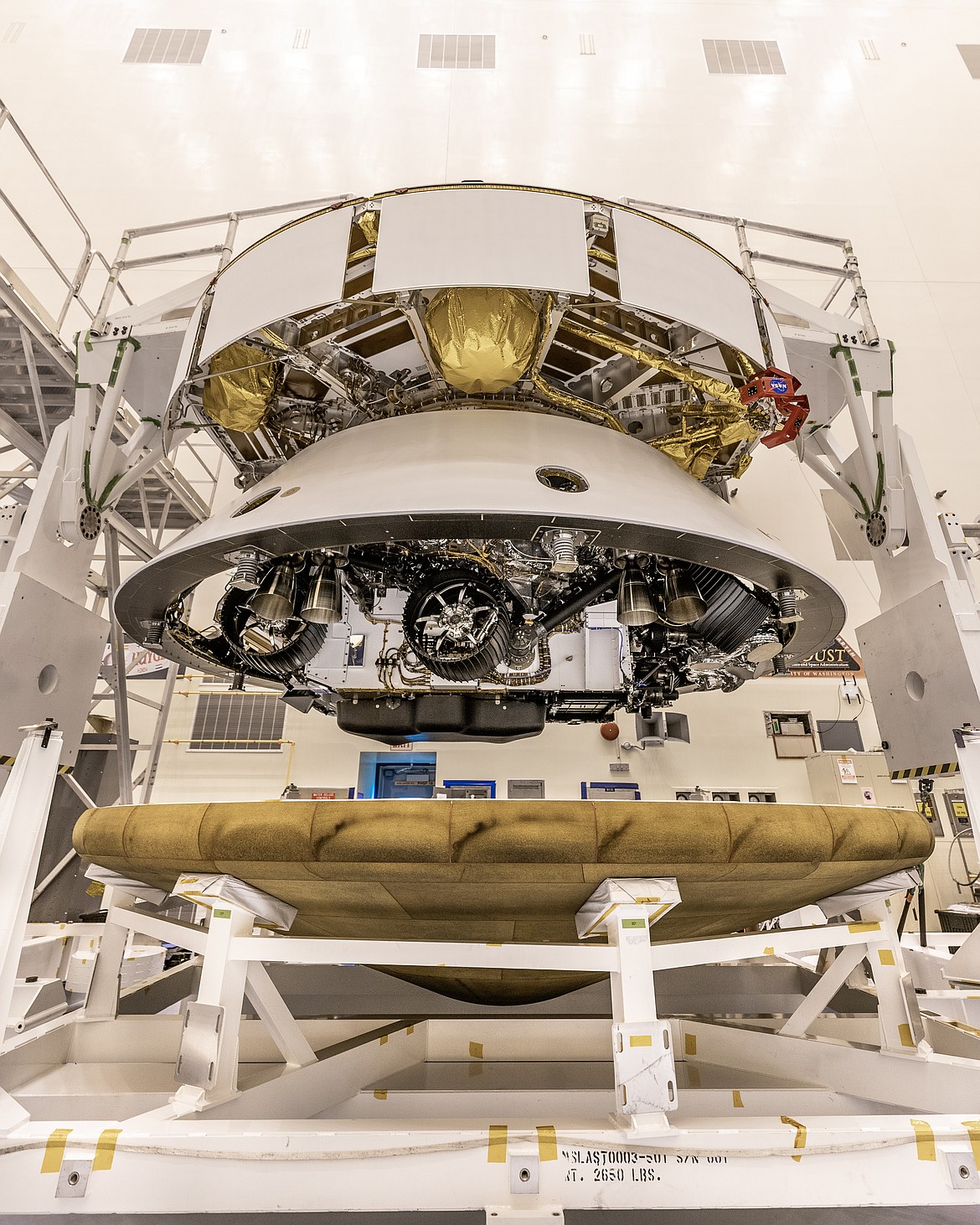 The Mars 2020 Perseverance rover mission’s disk-shaped cruise stage sits atop the bell-shaped back shell, which contains the powered descent stage and Perseverance rover. Below is the brass-colored heat shield that is about to be attached to the back shell. The next time the back shell and cruise stage will separate will be about 6 miles above Mars’ Jezero Crater in February 2021.
