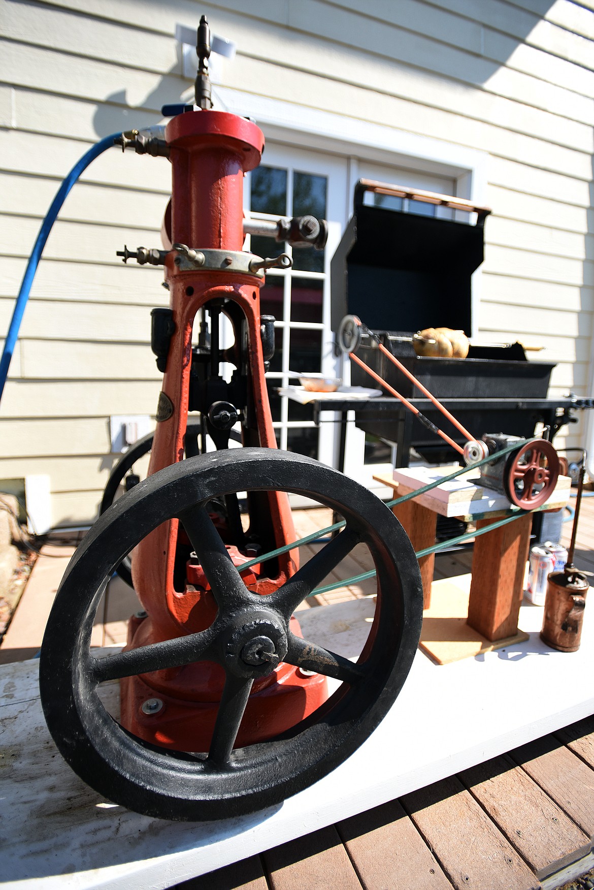 Built from an 1890s steam engine, a Weber grill and a collection of scavenged parts, Don Bumgarner’s rotisserie grill sits outside his house in Lakeside. (Jeremy Weber/Daily Inter Lake)