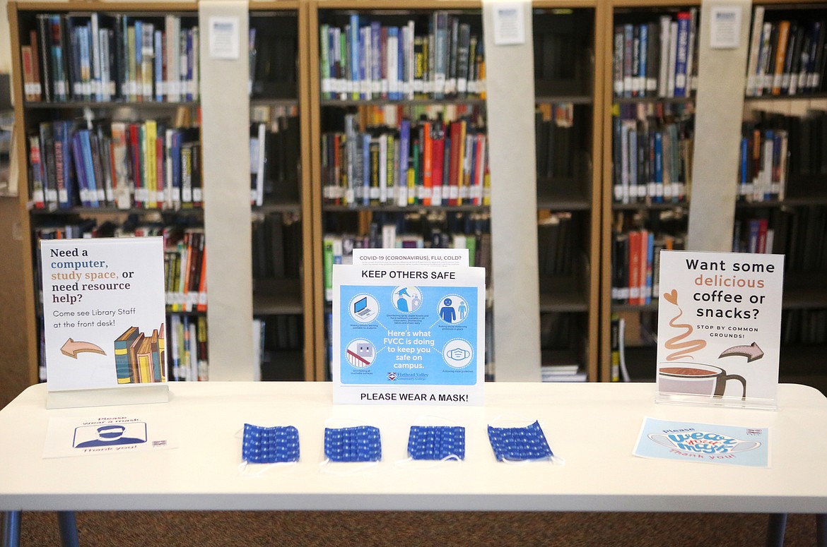 Signs encouraing the use of face masks and a supply of face masks greet visitors to the Broussard Family Library and Learning Commons at Flathead Valley Community College.  (Mackenzie Reiss/Daily Inter Lake)