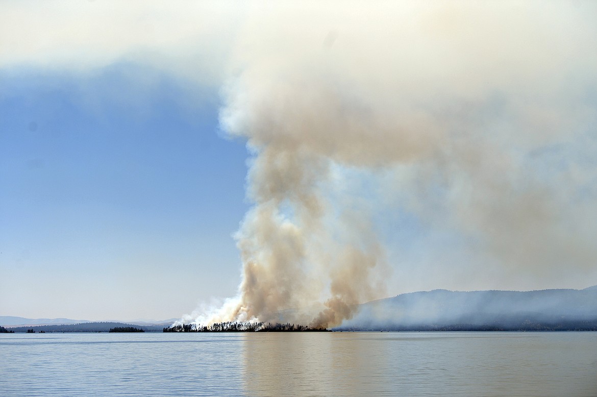 Plumes of smoke rise from a wildfire on Bird Island on Flathead Lake near Finley Point on Tuesday, Aug. 4. (Casey Kreider/Daily Inter Lake)