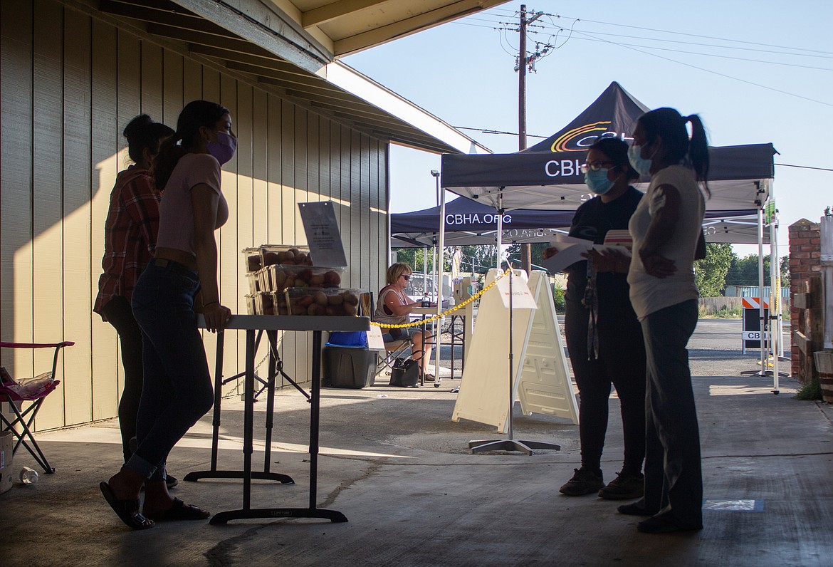 Casey McCarthy/The Sun Tribune 
 Booths were limited at the Othello Farmer's Market last Thursday due to high temperatures, but customers still found their way out for the afternoon.