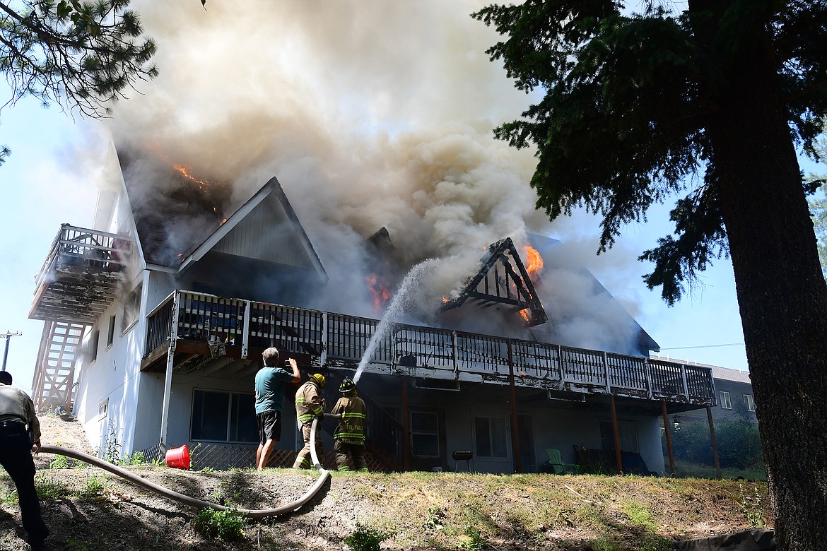 Columbia Falls firefighters fight an apartment fire on Fourth Avenue West Sunday afternoon.