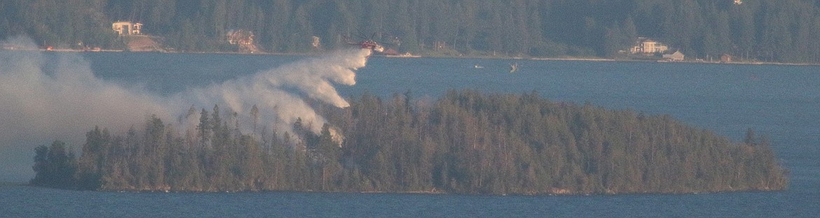 A plane drops water on a wildfire on Bird Island Monday evening. (Photo courtesy Charles Cain)