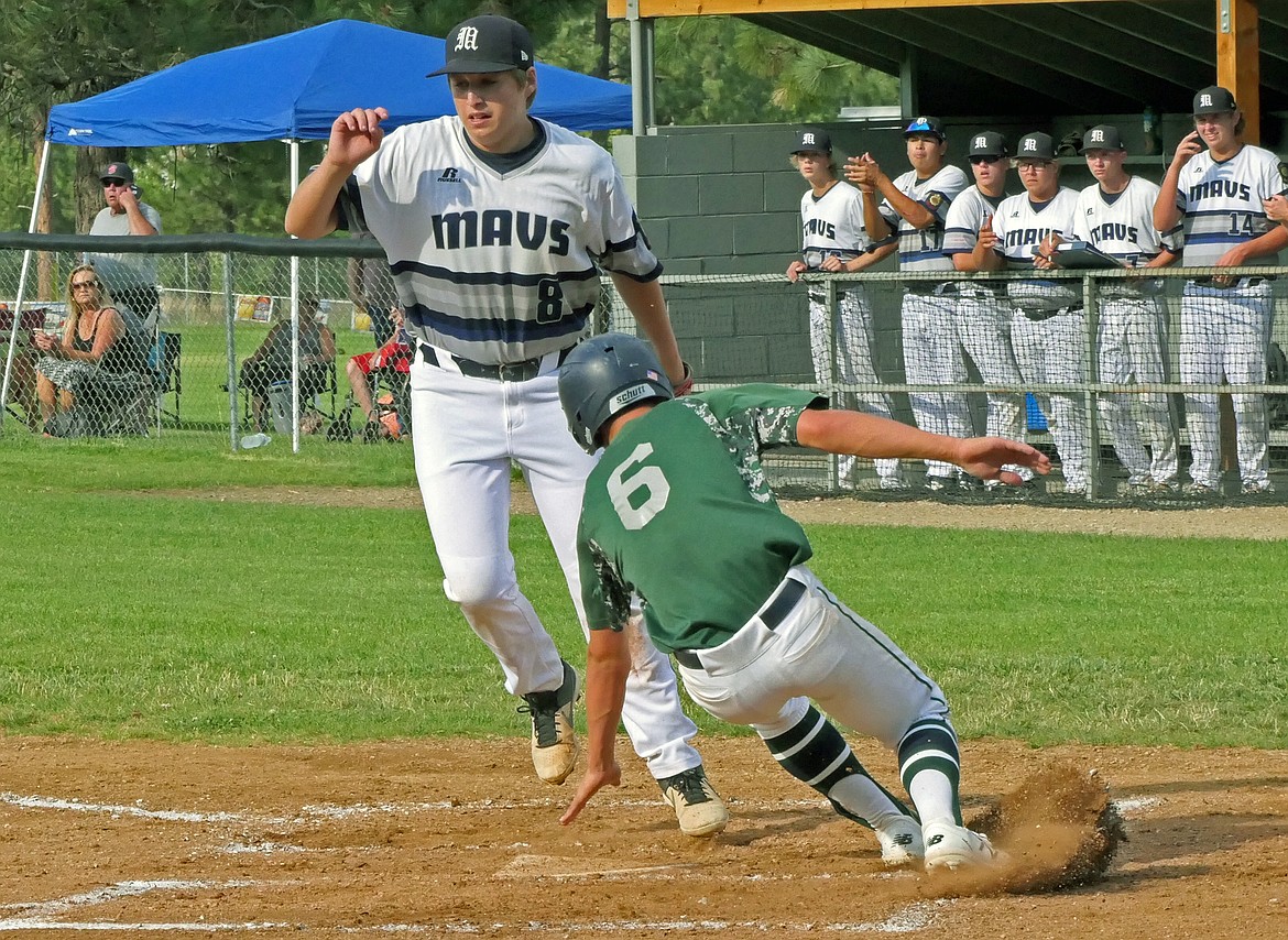 Mariners’ Xavier Fisher reaches to touch home plate as he records the first run of the game  against the Missoula Mavericks during the Class A Legion Baseball Western District Tournament on Thursday, July 30 in Florence. (Whitney England/Lake County Leader)