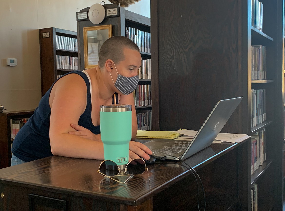 Library Assistant Amy Hille works on her laptop at Ritzville Public Library on Wednesday afternoon. Hille, and other Ritzville employees of the East Adams Library District, have worked to keep programs going since the shutdown, while also beginning new ones, such as a weekly trivia night.