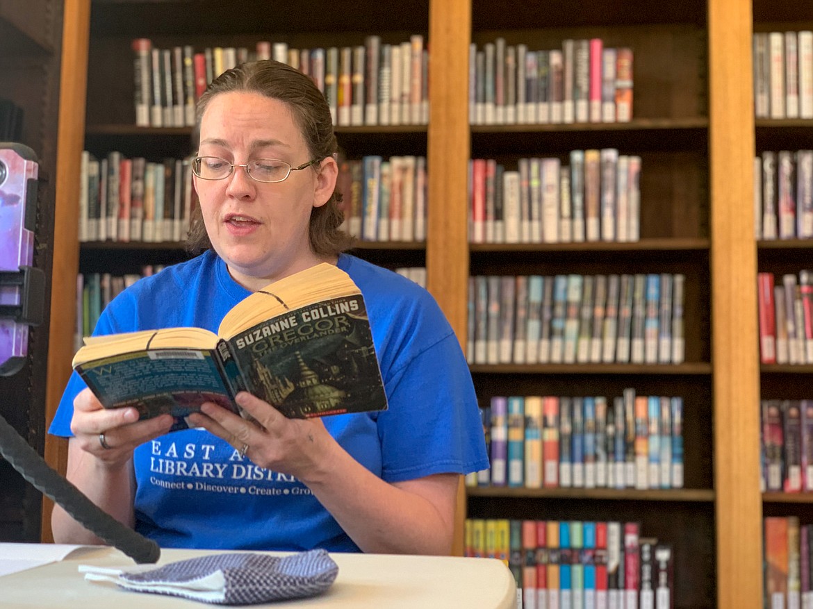 Millie Hopkins reads an excerpt from one of the Page Turners Book Club’s selections this week as she films this week’s installment in the program. Hopkins has worked to keep the youth programs active while the library is still unable to welcome patrons back inside.