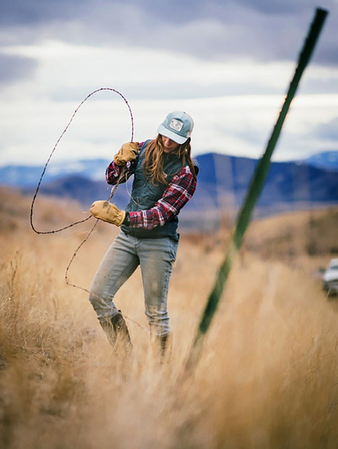 Brittany Masters installs fencing on the 10,000 acre property. (photo provided)