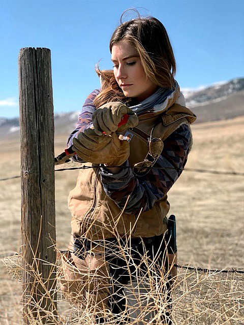 Brittany Masters works to install some of the more than 100 miles of fencing on the Roam Free Ranch. (photo provided)
