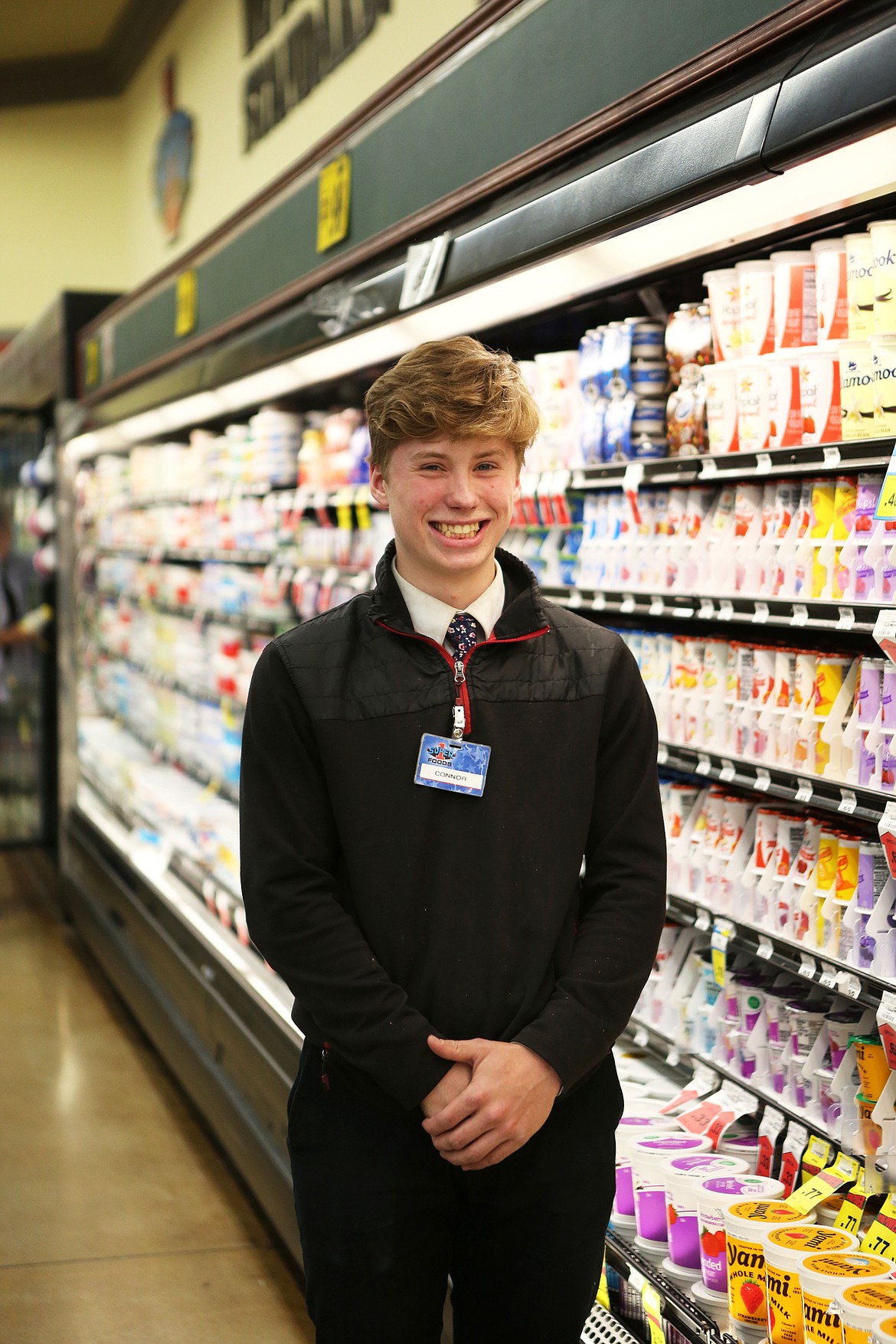 Connor Wride, a dairy stocker at Super One Foods is pictured in front of the diary display at Super One in Kalispell. (Mackenzie Reiss/Daily Inter Lake)