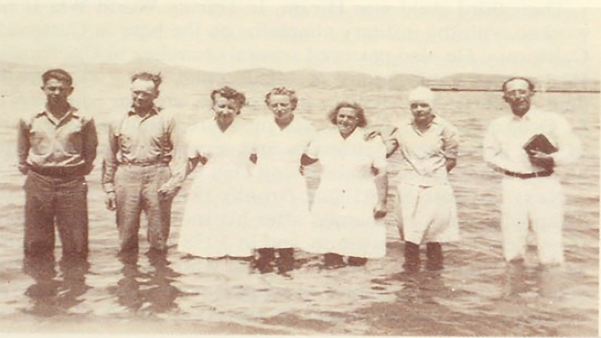 The first baptism of Polson’s New Life Church in the mid-1940s. The church’s founder, A.J. Morrison pictured with bible.