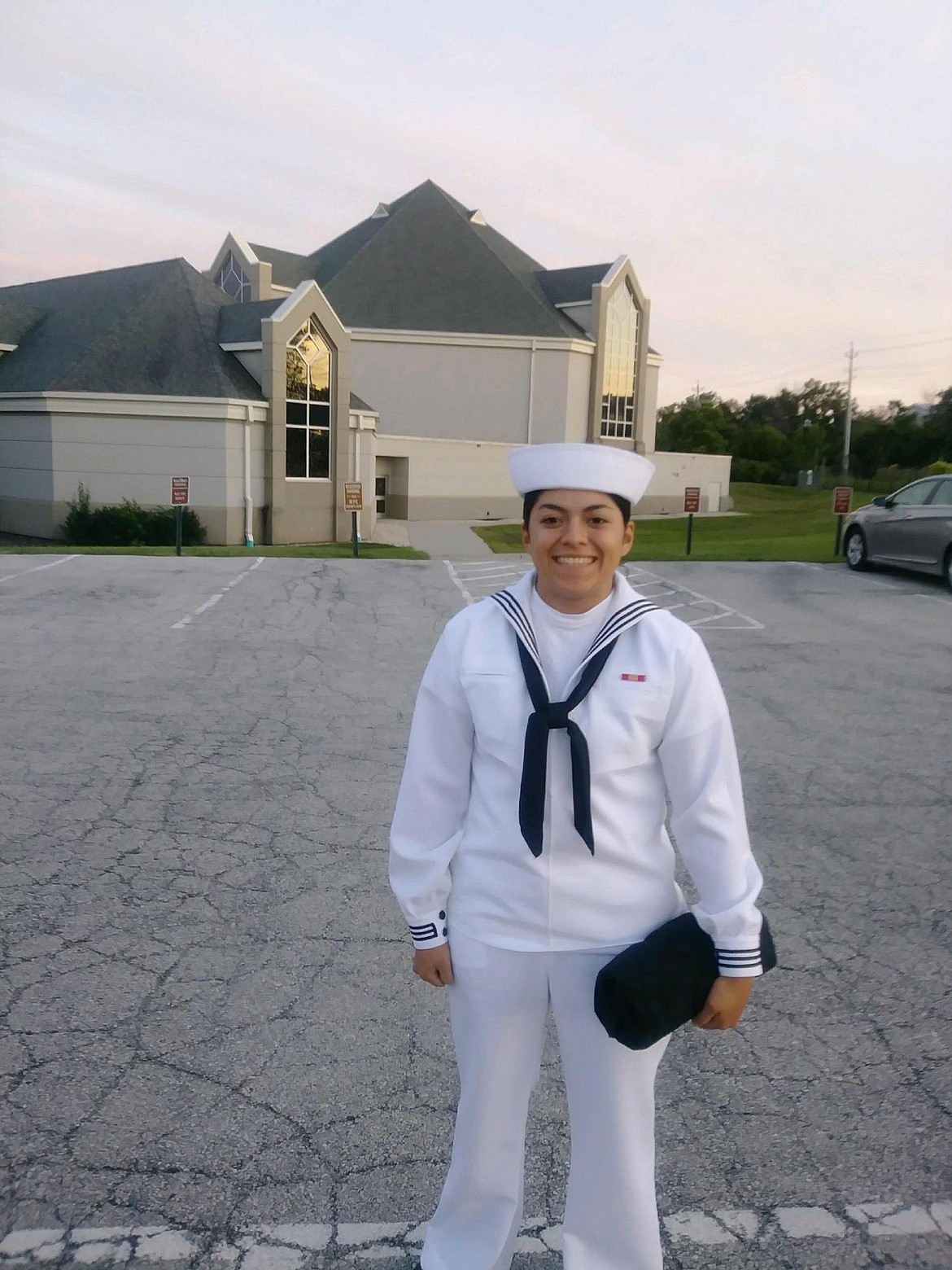 Julia Gutierrez-Carsten smiles in her dress uniform after graduating from her basic training at the Great Lakes Naval Training Center north of Chicago on Aug. 30, 2019.