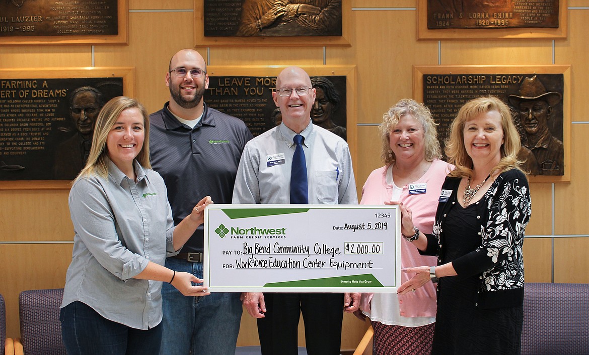 Dany Cavadini (left) and Scott Winkler (second from left) of Northwest Farm Credit Service present a check from the company’s foundation to Big Bend Community College president Terry Leas (center), Dean of Workforce Education Deneen Berry-Guerin (second from right) and BBCC foundation executive director LeAnne Parton (right) in August 2019.