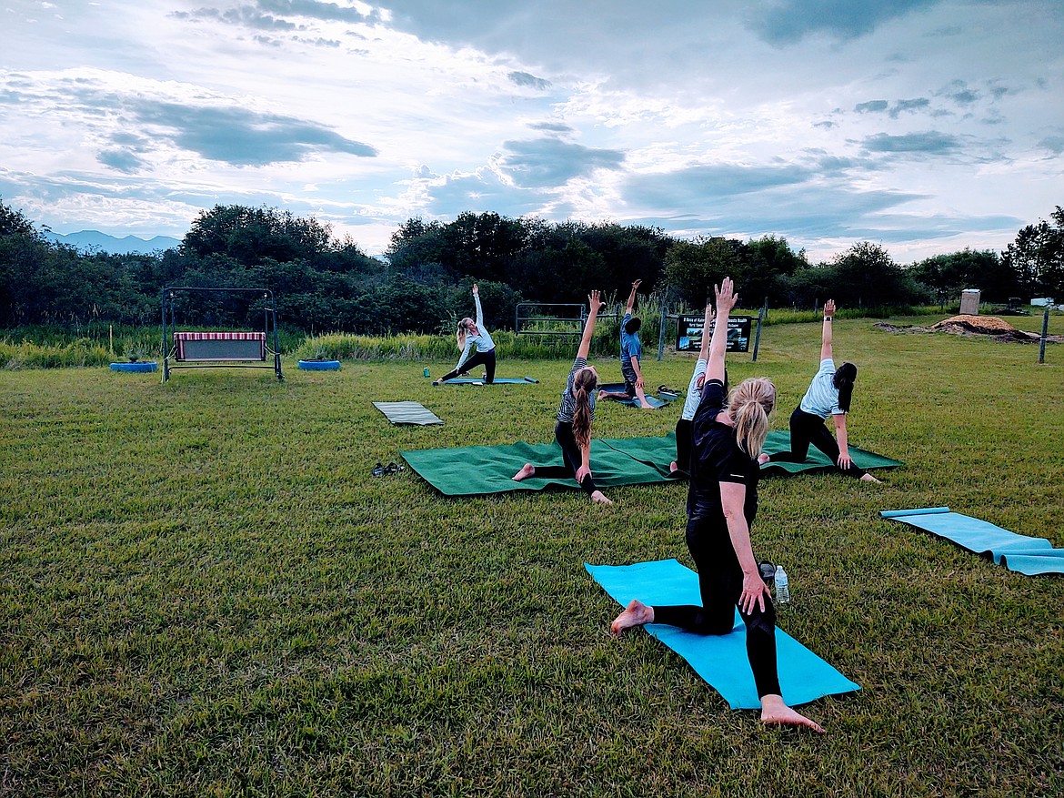 A yoga class practices on the grounds at Hurst Flower Meadow (courtesy photo).