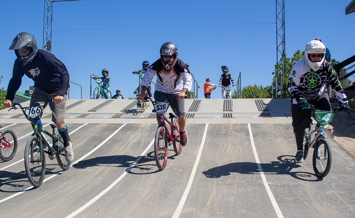 Casey McCarthy/Columbia Basin Herald
Left to right, Airick Wright, Kenneth Scott, and Tyson Drew head down the pavement from the start gate at the BMX track in Moses Lake during their heat of the single-point race event on Saturday.