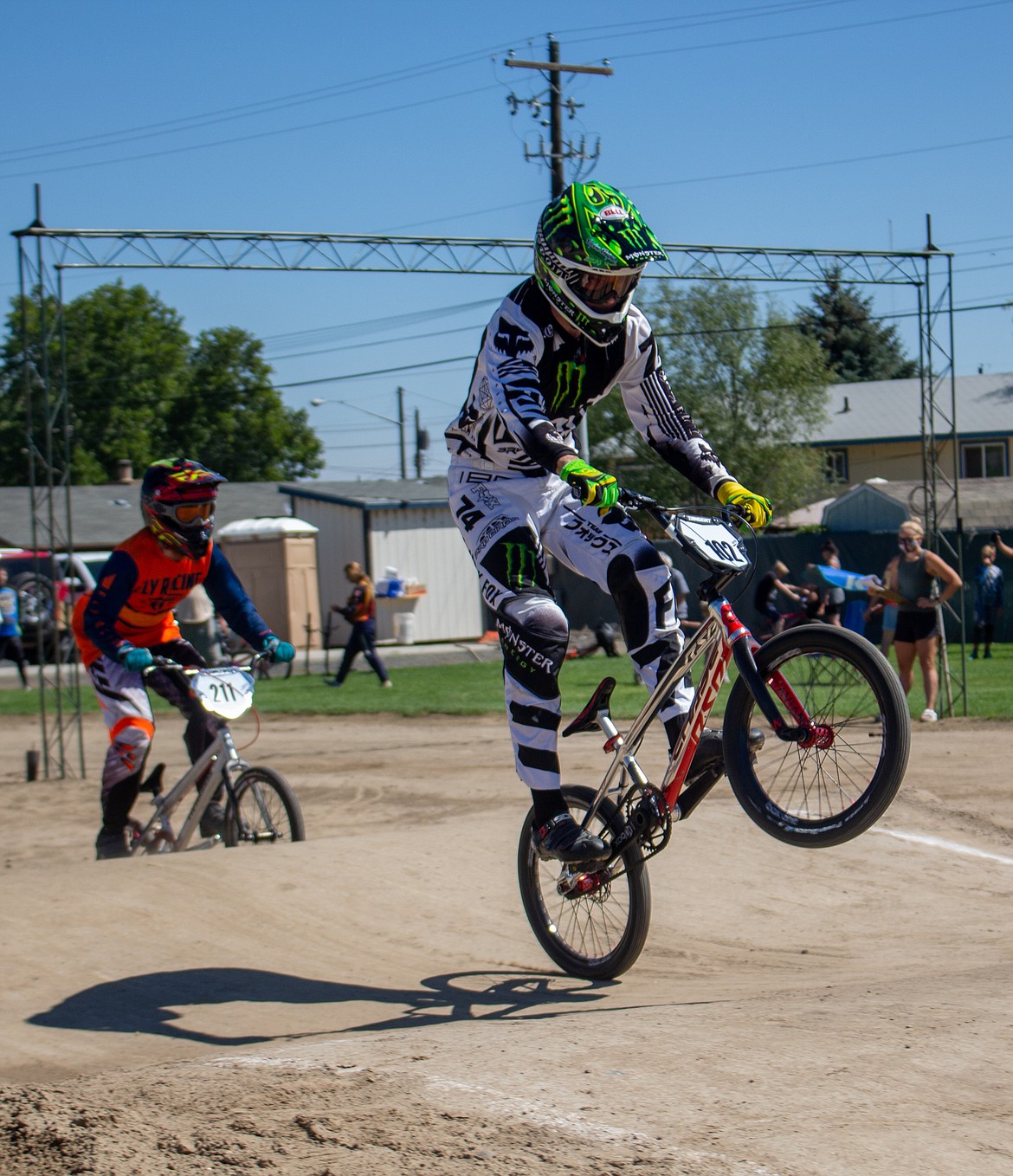 Casey McCarthy/Columbia Basin Herald 
 John Nelson, 23, rides out of a ramp during a heat at the single-point race event in Moses Lake on Saturday with Shane Hughes, 22, left, coming up in pursuit.