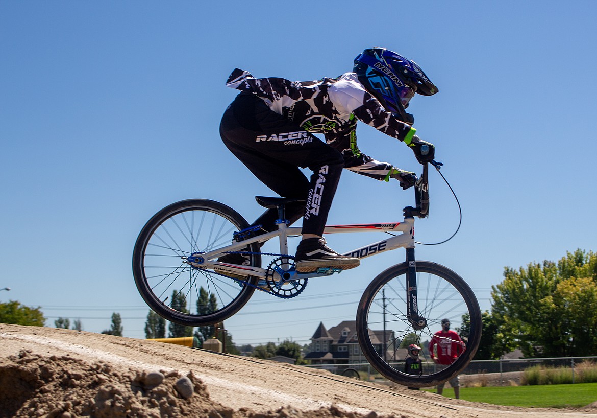 Dylan Hopkins-Drew, 9, floats above the dirt as he comes off the ramp at the BMX Track in Moses Lake on Saturday afternoon.