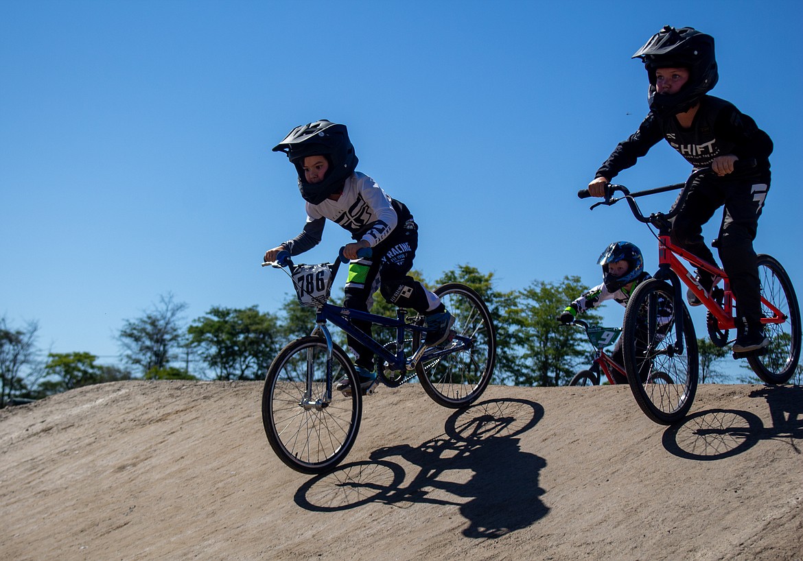 Casey McCarthy/Columbia Basin Herald
Matteo Garcia, 8, leads by a narrow margin as he and Jacob Reese, 9, pedal around the BMX track in Moses Lake on Saturday.