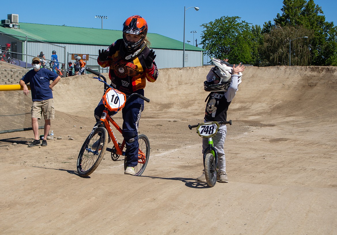 Casey McCarthy/Columbia Basin Herald
Benjamin Denton, 2, looks up at his older sister, as they signal they’re ready before he heads out for his “strider series” race at the BMX track on Saturday afternoon.