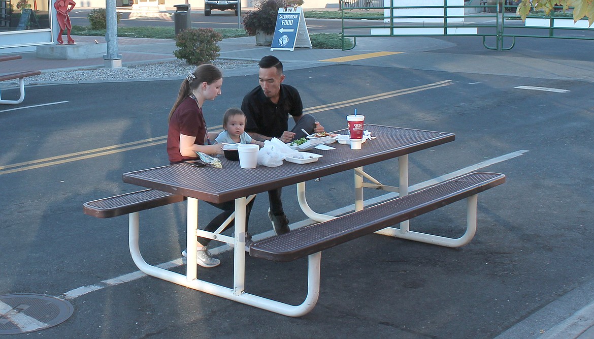 Laura Truong, left, and Minh Truong enjoy dinner Friday evening with their 14-month-old daughter, Mia.