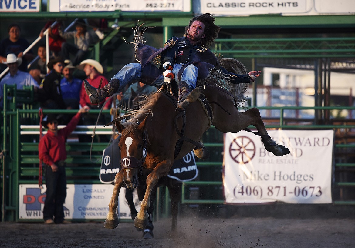 Tilden Hooper, from Carthage, Texas, holds on to his horse during saddle bronc riding at the Northwest Montana Fair & Rodeo on Thursday, Aug. 20. (Casey Kreider/Daily Inter Lake)