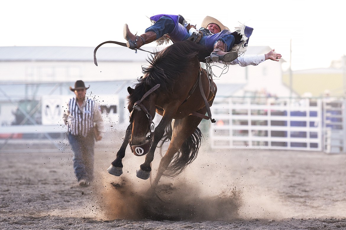 Caleb Bennett from Corvallis holds on to his horse during saddle bronc riding at the Northwest Montana Fair & Rodeo on Thursday, Aug. 20. (Casey Kreider/Daily Inter Lake)