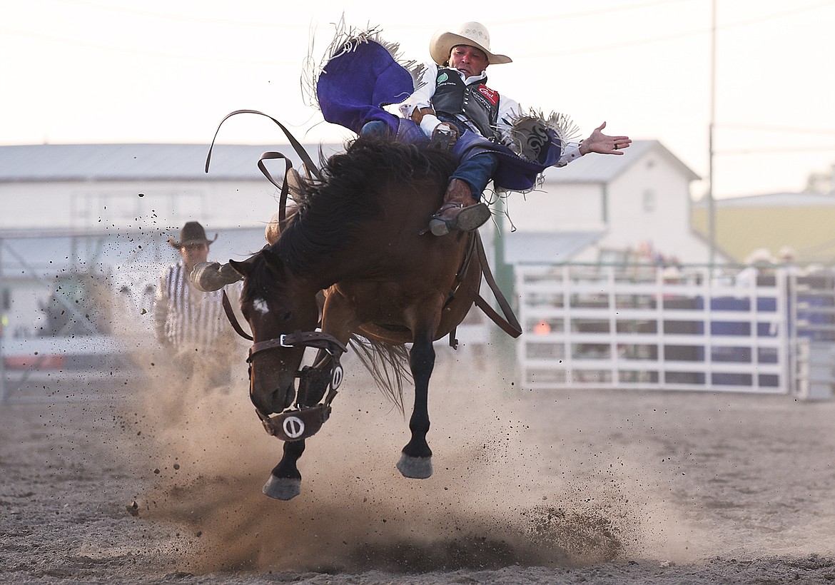 Caleb Bennett, from Corvallis, holds on to his horse during saddle bronc riding at the Northwest Montana Fair & Rodeo on Thursday, Aug. 20. (Casey Kreider/Daily Inter Lake)