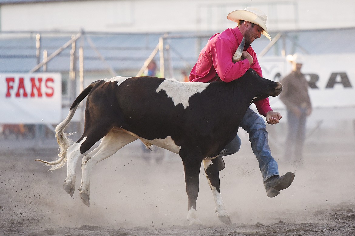 Landon Beardsworth, from Red Deer County, Alberta, Canada, takes his steer to the ground during steer wrestling at the Northwest Montana Fair &. Rodeo on Thursday, Aug 20. (Casey Kreider/Daily Inter Lake)