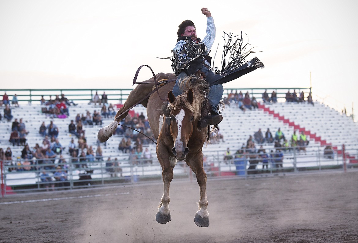 Wyatt Denny, from Minden, Nevada, holds on to his horse during saddle bronc riding at the Northwest Montana Fair & Rodeo on Thursday, Aug. 20. (Casey Kreider/Daily Inter Lake)