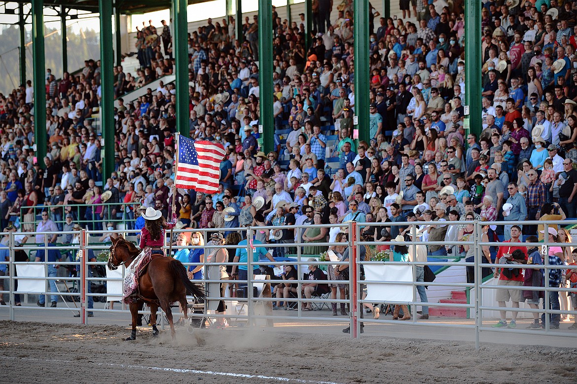 Fans get ready for the national anthem at the Northwest Montana Fair & Rodeo on Saturday, Aug. 22. (Casey Kreider/Daily Inter Lake)